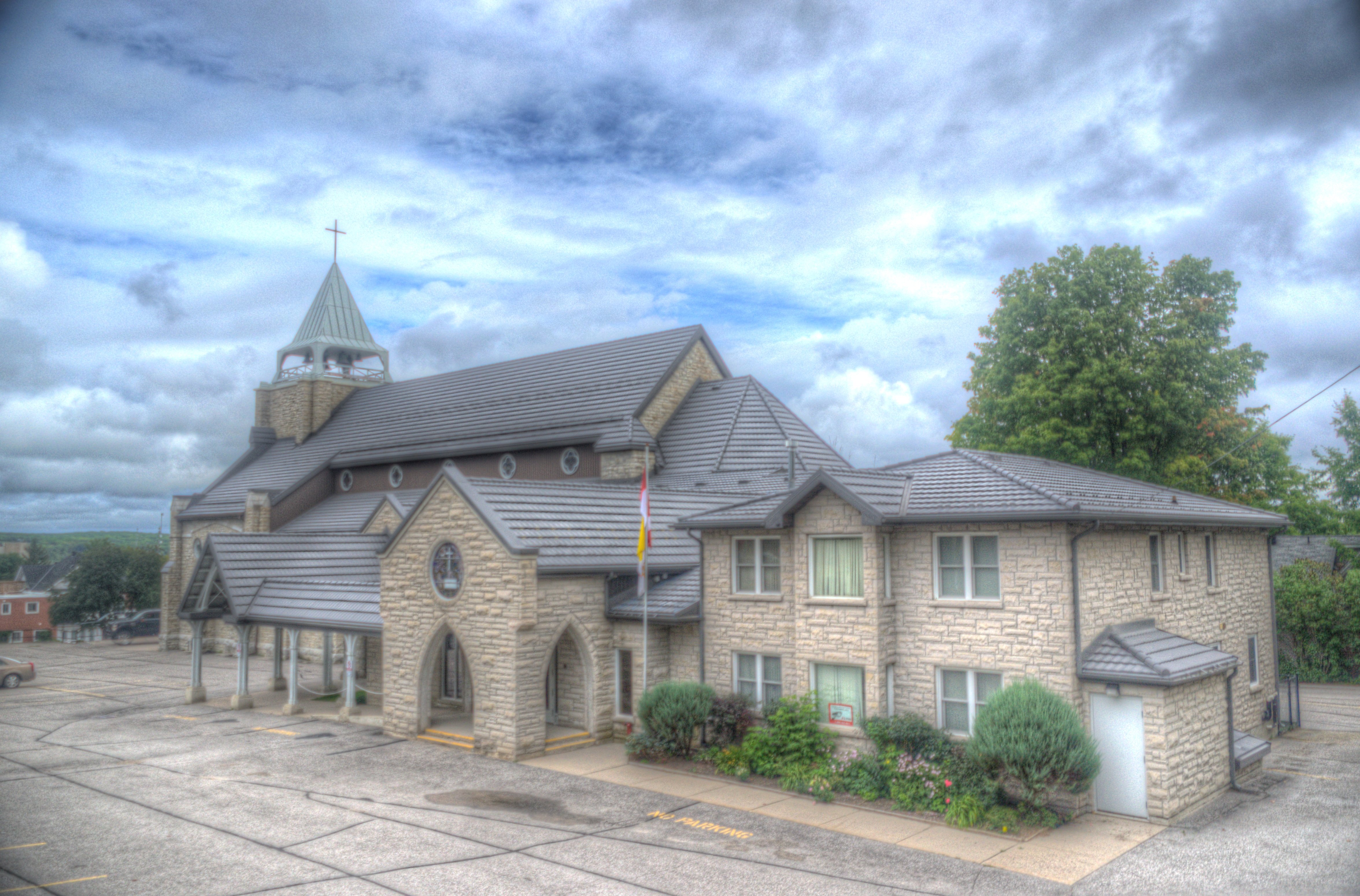 Outside image of St. Margaret's office side with beautiful clouds.